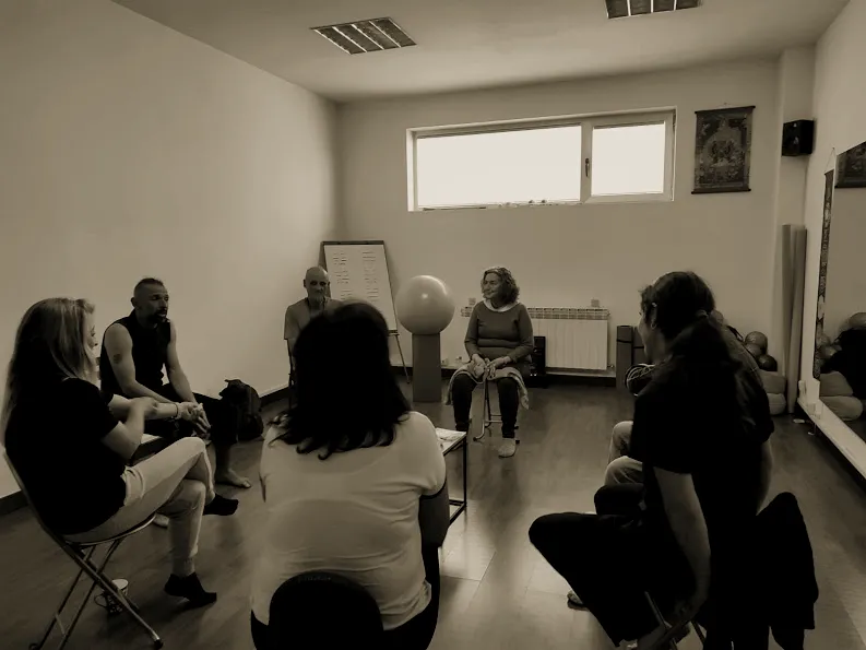Personas sentadas en círculo durante una actividad de la escuela